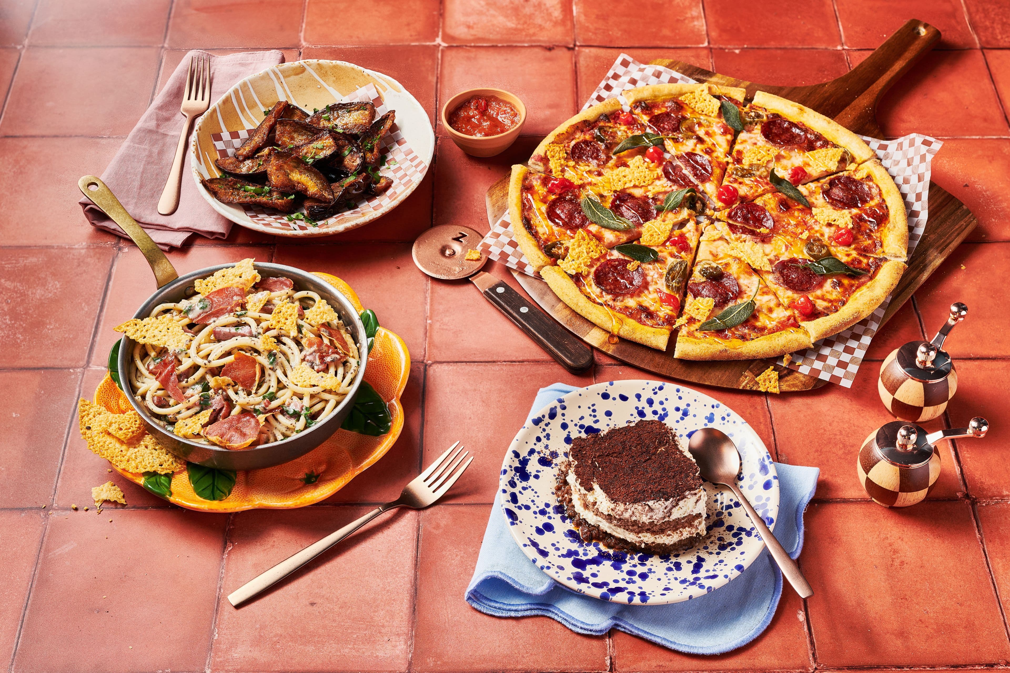 Feast shot featuring Truffle Carbonara, Venison Pepperoni Pizza and Tiramisu